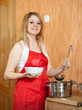 Photo: Woman with saucepan Woman with saucepan