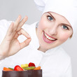 Female chef baker in uniform shows ok for a dessert