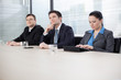Business people at a meeting, listening to their superior