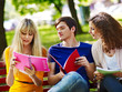 Foto: Group student with notebook on bench outdoor. Group student with notebook on bench outdoor.