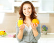 Healthy Girl with Orange Juice in the Kitchen