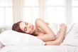 Beautiful woman lying down in bed