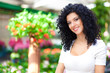 Smiling florist in a greenhouse