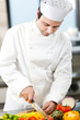 Young chef cutting vegetables in a kitchen