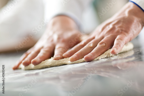 Photo: Chef preparing pizza dough Chef preparing pizza dough