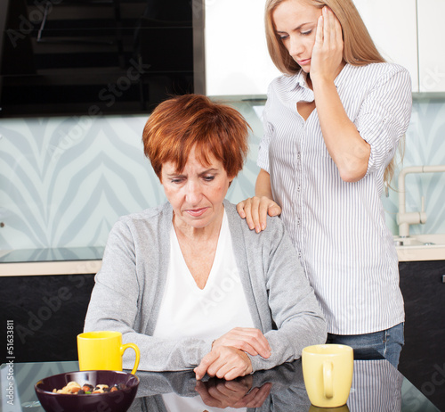 Photo: Daughter soothes sad mother Daughter soothes sad mother