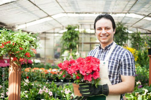 Photo: Man holding a flower pot Man holding a flower pot