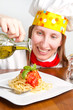 Photo: smiling chef garnish an Italian pasta dish smiling chef garnish an Italian pasta dish