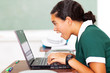 surprised middle school girl looking at her laptop