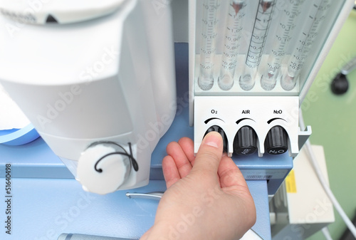 Photo: doctor adjusts the parameters of medical rotameter on the anesth doctor adjusts the parameters of medical rotameter on the anesth
