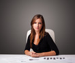 Businesswoman sitting at desk and doing paperwork