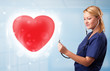 Young nurse healing a red heart