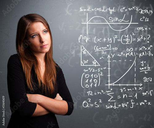 Photo: Beautiful school girl thinking about complex mathematical signs Beautiful school girl thinking about complex mathematical signs