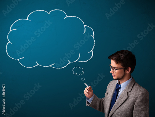 Photo: Young man smoking cigarette with idea cloud Young man smoking cigarette with idea cloud