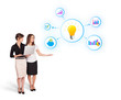 beautiful young women presenting light bulb with colorful graphs