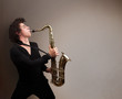 Young musician playing on saxophone