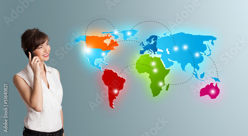 Photo: young woman making phone call with colorful world map young woman making phone call with colorful world map