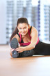 Foto: Woman doing stretching exercises at the gym Woman doing stretching exercises at the gym