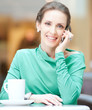 Photo: Beautiful business woman talking on cell phone Beautiful business woman talking on cell phone