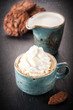 Сup of coffee with whipped cream and chocolate cookies