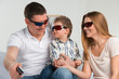 Family laughing while watching television together in the living