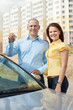   happy couple against real estate