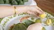 woman use hand wrap stuffed dough pyramid thailand dessert