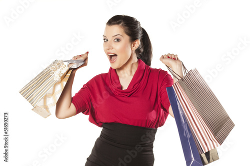 Photo: happy and smiling blue-eyed brunette holding shopping bags happy and smiling blue-eyed brunette holding shopping bags