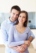 Young couple hugging at home