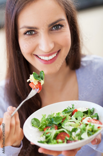 Photo: Woman eating salad Woman eating salad