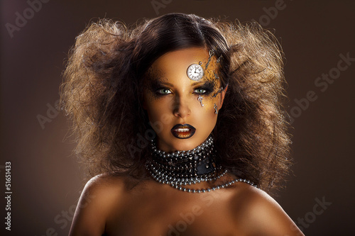 Photo: Bronze Face of Beautiful Woman with Silver Watch and Keys Bronze Face of Beautiful Woman with Silver Watch and Keys