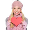 Smiling girl in winter clothes showing heart shaped postcard
