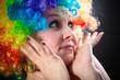 Woman in clown's wig smiling pulling fake hair on the sides
