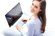 Photo: Woman sitting on bed with laptop Woman sitting on bed with laptop