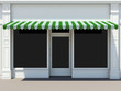 Shopfront in the sun - classic store front with green awnings