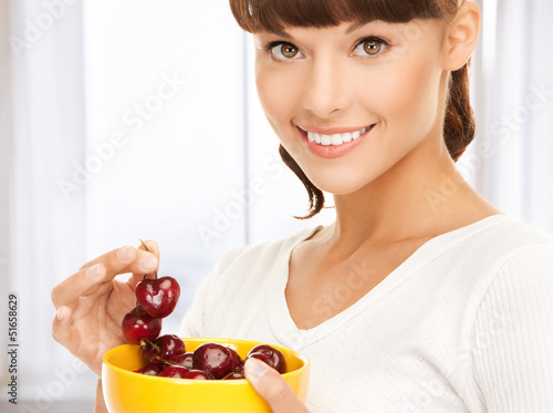 Photo: healthy woman holding bowl with cherries healthy woman holding bowl with cherries