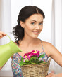 housewife with flower in basket and watering can