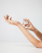 woman hands spraying perfume