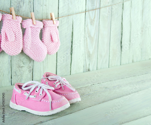 Photo: Toddler shoes on wooden vintage background Toddler shoes on wooden vintage background