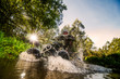 Quad rider through water stream