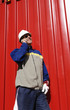hardhat worker against red iron background