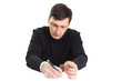 Photo: The man in handcuffs writes something a ball pen. The man in handcuffs writes something a ball pen.