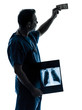 Photo: doctor surgeon man examing dollar bill silhouette doctor surgeon man examing dollar bill silhouette