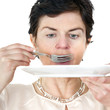 Photo: Woman with plate and fork in hand Woman with plate and fork in hand