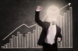 Photo: Businessman with lightbulb head raised hand Businessman with lightbulb head raised hand