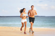People running - young couple jogging on beach
