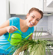 Foto: woman watering flowers woman watering flowers