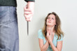 Man with knife coming to his wife. Home violence concept