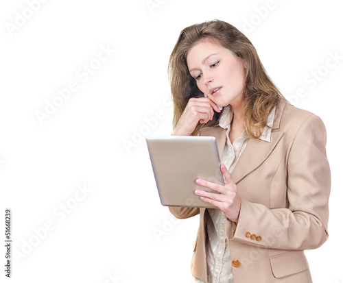 Photo: Young woman holding tablet pc and calling on the phone Young woman holding tablet pc and calling on the phone