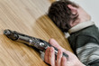Man with gun laying on the floor